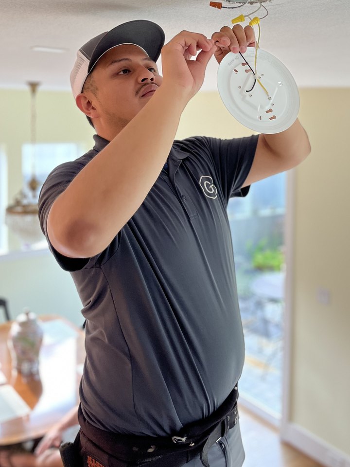 Erik, Goodsmith electrician, wiring a light fixture